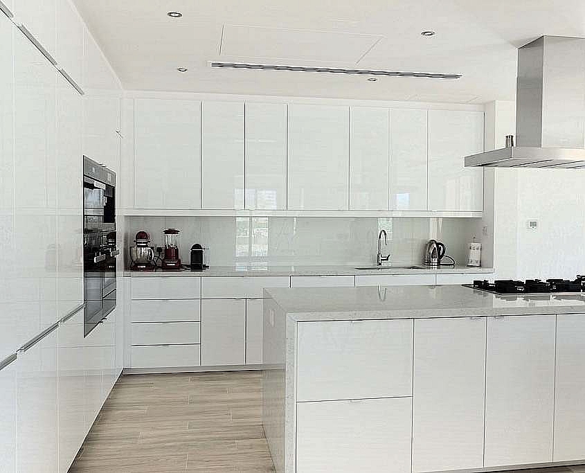After renovation Bright modern white kitchen with integrated appliances showcasing a completed kitchen remodel in Dubai